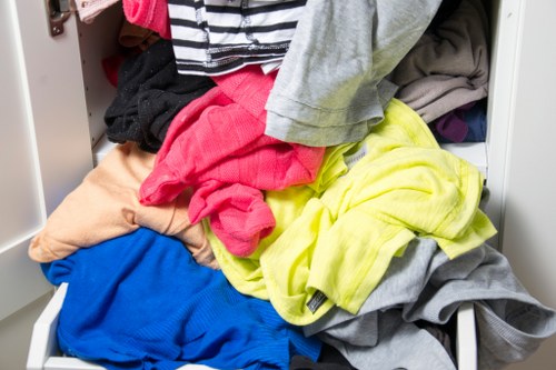 Two movers carrying office desk down stairs in Marylebone