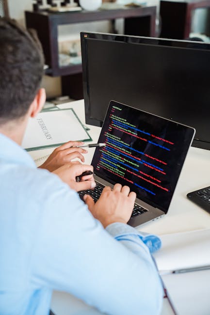 A close-up photograph of a computer screen displaying lines of HTML code in various colors, including red, yellow, green, and blue. The code features tags such as <h1> for a heading, <div> and <img> f